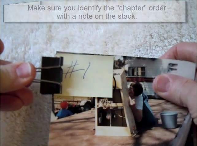 Checking the back of a photo for dried glue residue