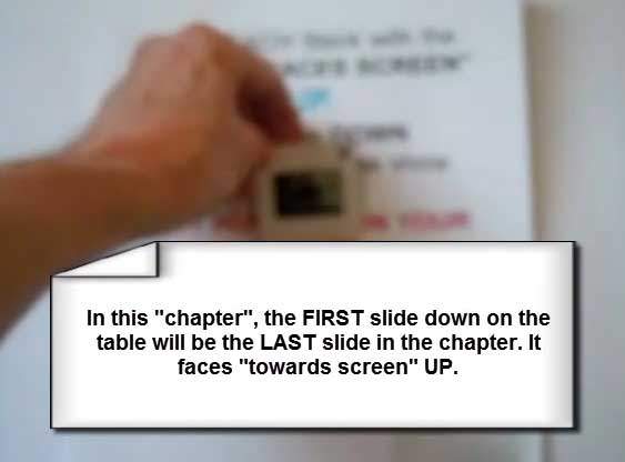 Holding slide to light to see text backwards from the back side