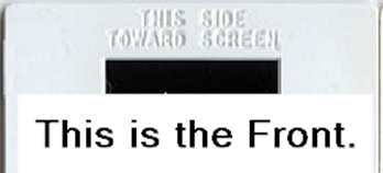 Plastic slide mount labeled ‘This Side Toward Screen’ indicating the Front